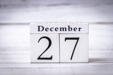 27 Aralık tarihini gösteren dekoratif ahşap bir takvim. Bloklar ay ve günü açıkça gösteriyor. Mevsimsel dekorasyon ve planlama için mükemmel..