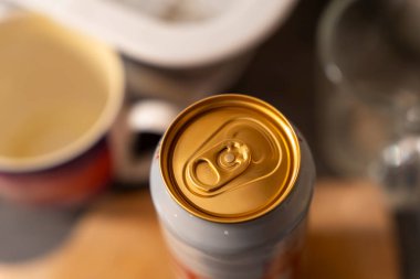 İçeceklerin tüketime hazır olduğunu gösteren çeşitli mutfak eşyalarıyla çevrili bir kola kutusunun yakın plan görüntüsü..