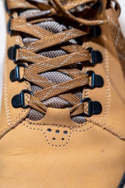 Yürüyüş ayakkabısı bağcıklarının kahverengi tonlarda detaylı bir yakın plan çekimi işçilik ve tasarım sergiliyor. Açık hava vitesi pazarlama macera kampanyaları ve yaşam tarzı markalaşması için ideal..