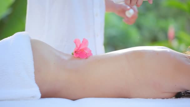 Focussed massage with flower — Stock Video