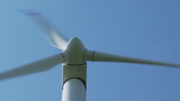 Вращающаяся ветряная мельница на голубом небе — стоковое видео