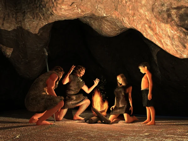 Cave invånare samlades runt en lägereld Royaltyfria Stockbilder