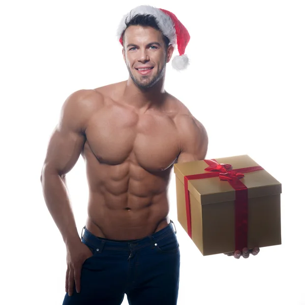 Muscular, sexy santa claus with gift on white background — Stock Photo, Image