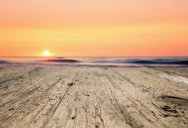 Wooden planks on the beach at sunset — Stock Photo, Image