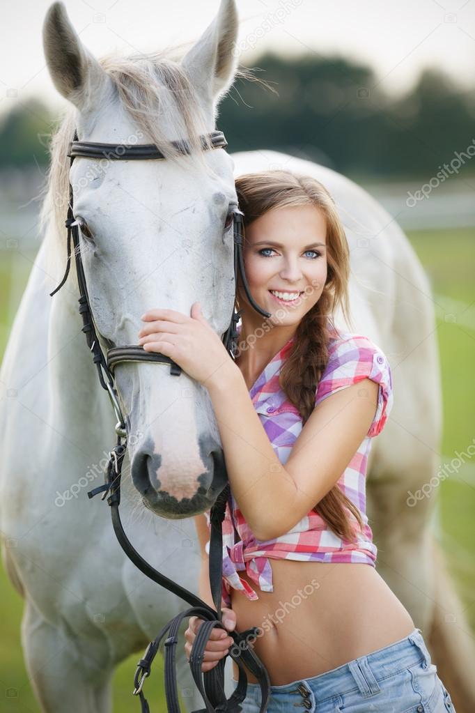 Beautiful smiling woman with gray horse
