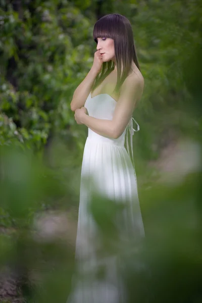 Woman in a white dress in the orchard — Stock Photo, Image