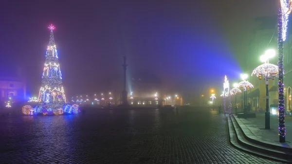 Christmas decorations on the old town of Warsaw in fog — Stock Photo, Image