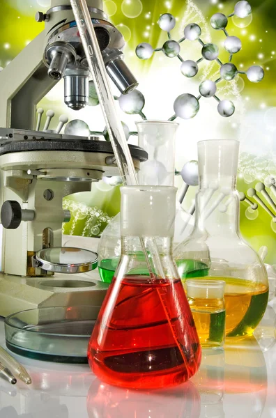 Image of laboratory glassware and microscopy on DNA strand background — Stock Photo, Image