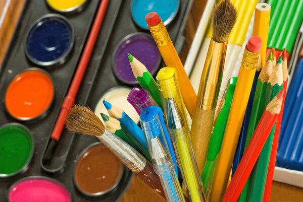 image of paints and colored pencils close-up