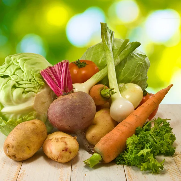 Different vegetables on a green background — Stock Photo, Image