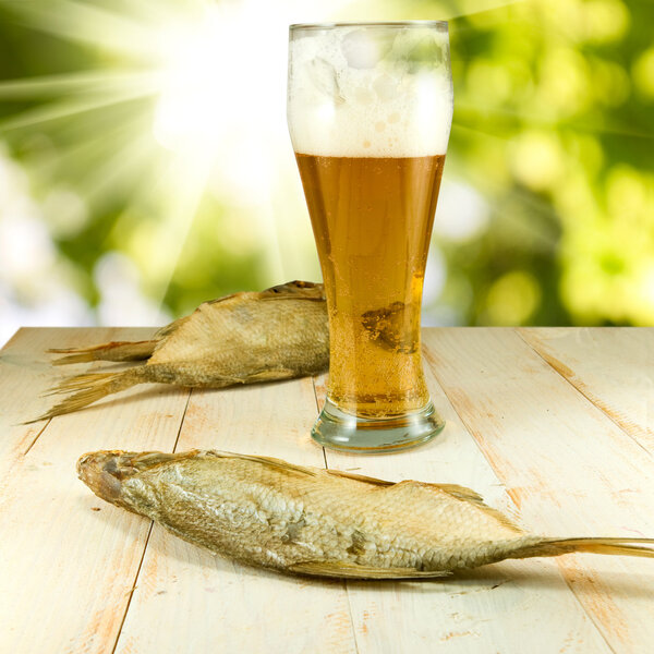 glass of beer and dried fish 