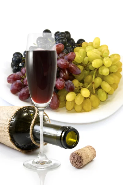 Bottle,  glass of wine and a plate with grapes — Stock Photo, Image