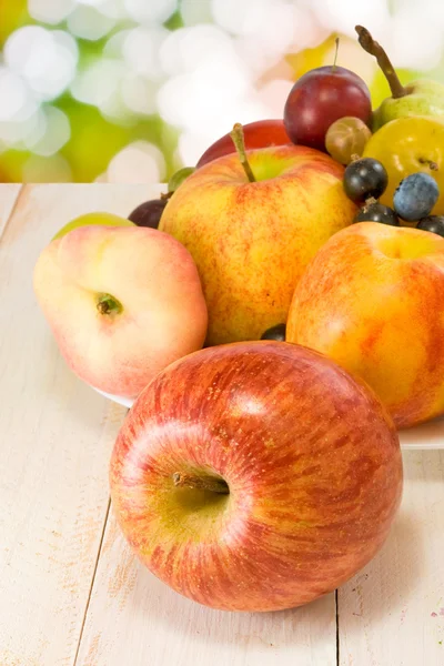 Different fruits on green background — Stock Photo, Image