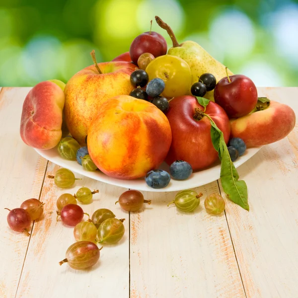 Different fruits on a plate — Stock Photo, Image