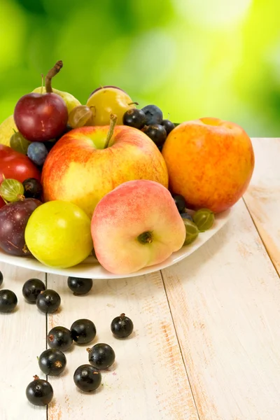Various ripe fruits on a plate — Stock Photo, Image