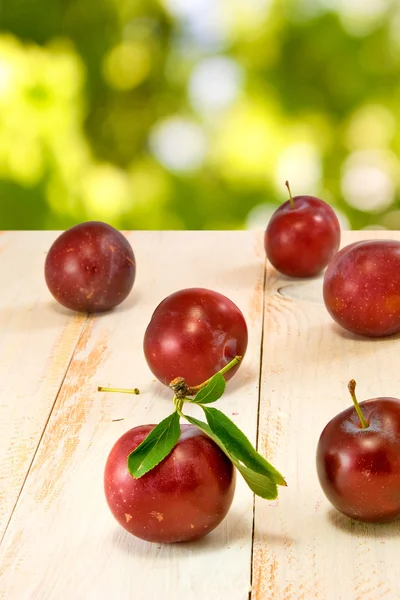 Plums on green background closeup — Stock Photo, Image