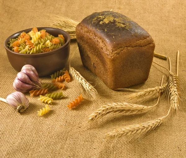 Pasta, bread, garlic and wheat — Stock Photo, Image