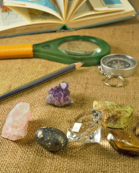 Minerals, atlas, magnifier, pencil and compass closeup — Stock Photo, Image