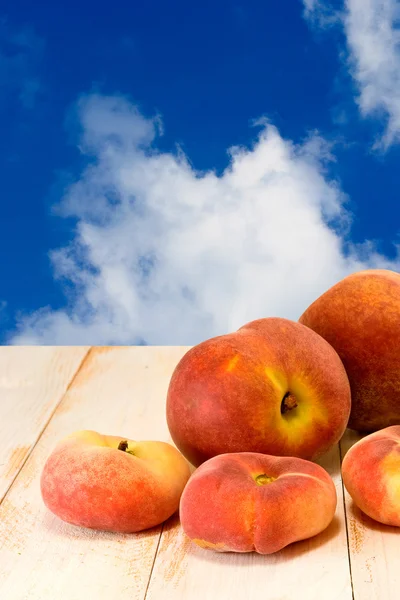 Peach on blue sky background — Stock Photo, Image