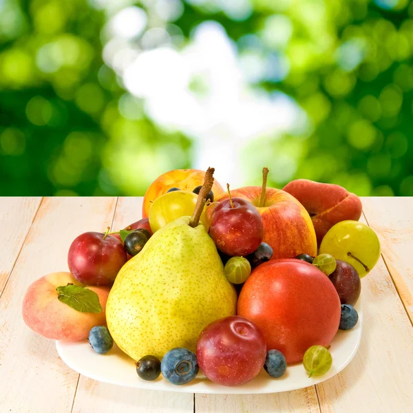 Various ripe fruits on a plate — Stock Photo, Image