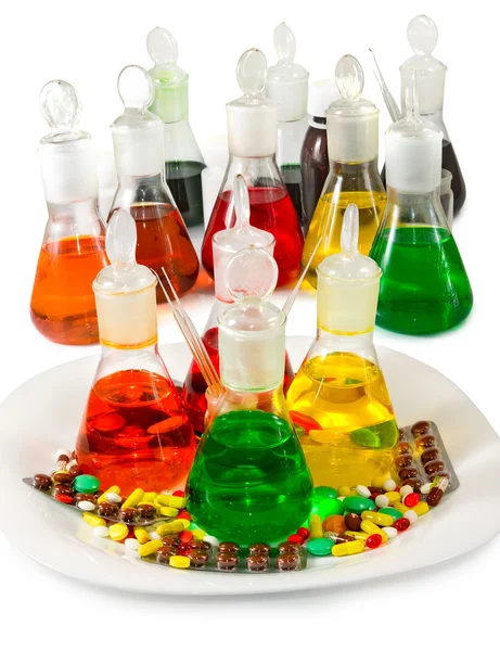 Flasks with colored liquid and pills — Stock Photo, Image