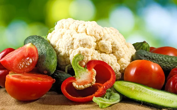 Image of various ripe fruits on a green background — Stock Photo, Image