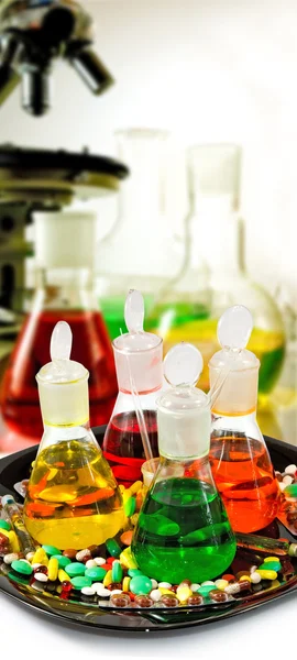 Kimyasal şişeler, mikroskop ve hapları — Stok fotoğraf
