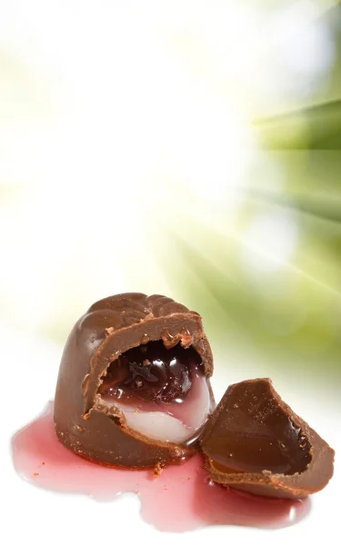 Изолированное изображение вкусного шоколада с вишней на зеленом фоне — стоковое фото