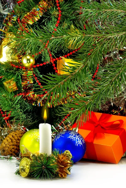 Image of a burning candle on the Christmas tree background close-up — Stock Photo, Image