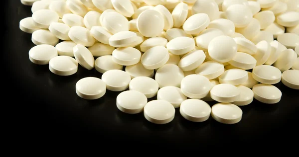 Pills on a black background closeup — Stock Photo, Image