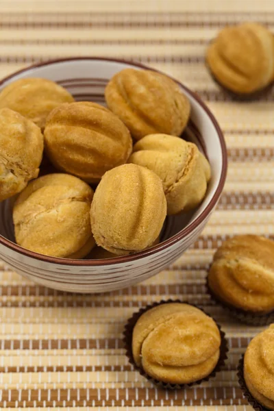 Walnut shaped cookies with caramel and walnuts — Stock Photo, Image