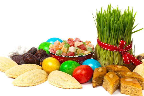 Colored eggs, wheat springs and candy — Stock Photo, Image