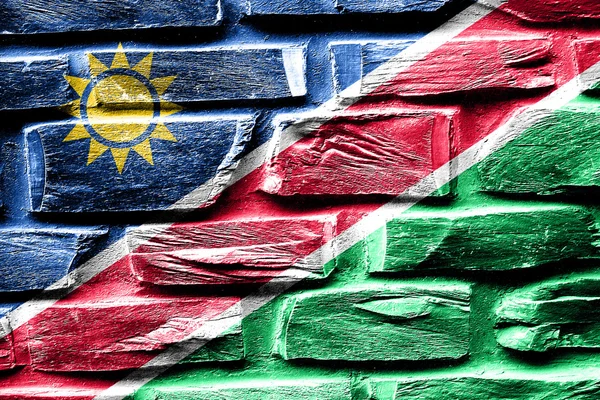 Ladrillo pared Namibia bandera con algunas grietas y aspecto vintage — Foto de Stock
