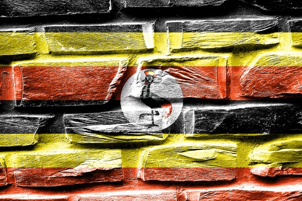 Muro de ladrillo Bandera de Uganda con algunas grietas y aspecto vintage — Foto de Stock