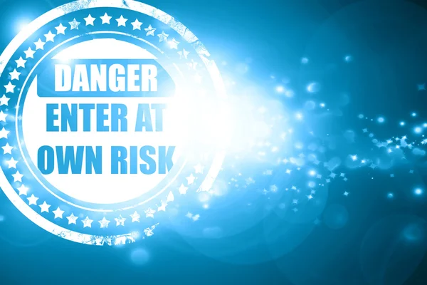 Blue stamp on a glittering background: enter at own risk — Stock Photo, Image