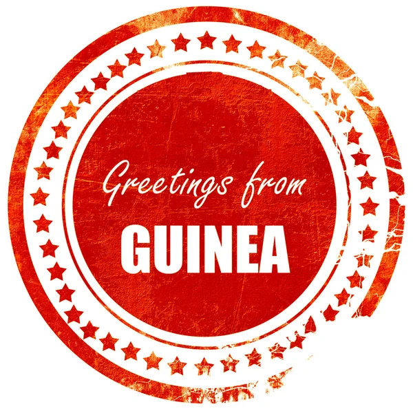 Saludos de guinea, sello de goma roja grunge en un blanco sólido —  Fotos de Stock