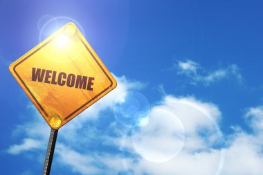 Yellow road sign with a blue sky and white clouds: welcome