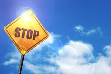 Yellow road sign with a blue sky and white clouds: stop sign bac