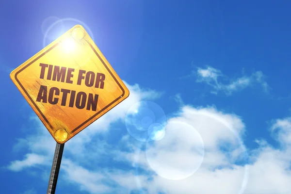 Yellow road sign with a blue sky and white clouds: time for acti — Stock Photo, Image