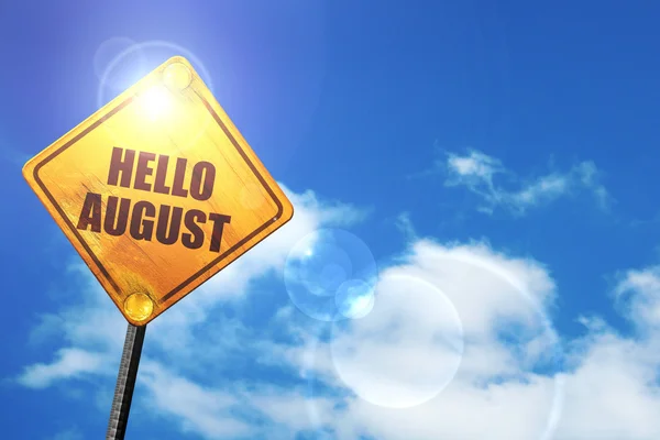 Yellow road sign with a blue sky and white clouds: hello august — Zdjęcie stockowe