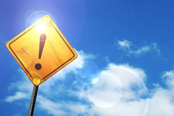 Yellow road sign with a blue sky and white clouds: Hazard warnin — Stock Photo, Image
