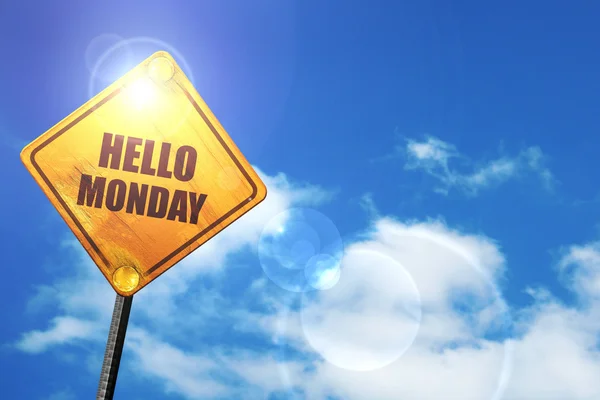 Yellow road sign with a blue sky and white clouds: hello monday — 스톡 사진