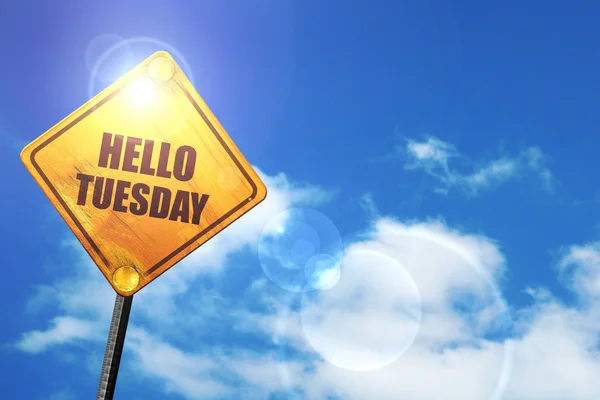 Yellow road sign with a blue sky and white clouds: hello tuesday — 스톡 사진