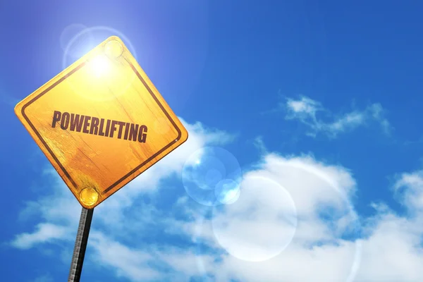 Yellow road sign with a blue sky and white clouds: power lifting — 图库照片