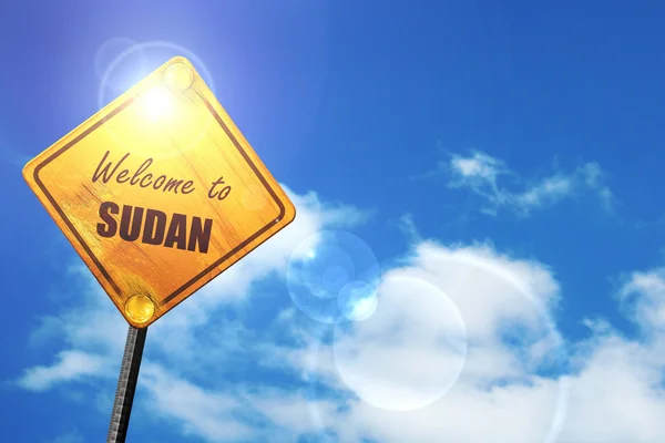 Yellow road sign with a blue sky and white clouds: Welcome to su — Stock fotografie