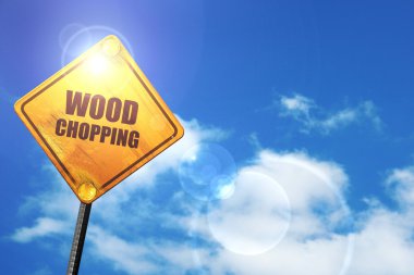Yellow road sign with a blue sky and white clouds: wood chopping