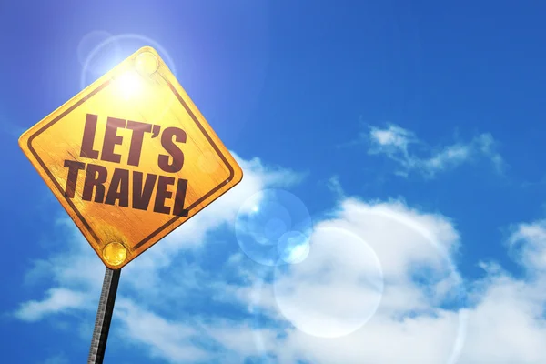 Yellow road sign with a blue sky and white clouds: lets travel — Stock Photo, Image