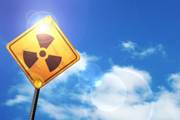 Yellow road sign with a blue sky and white clouds: Nuclear dange — Stock Photo, Image