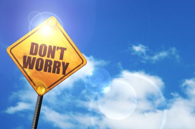 Yellow road sign with a blue sky and white clouds: dont worry