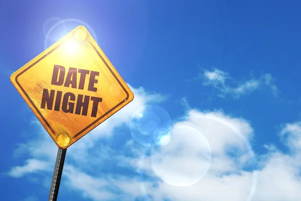 Yellow road sign with a blue sky and white clouds: date night — Φωτογραφία Αρχείου